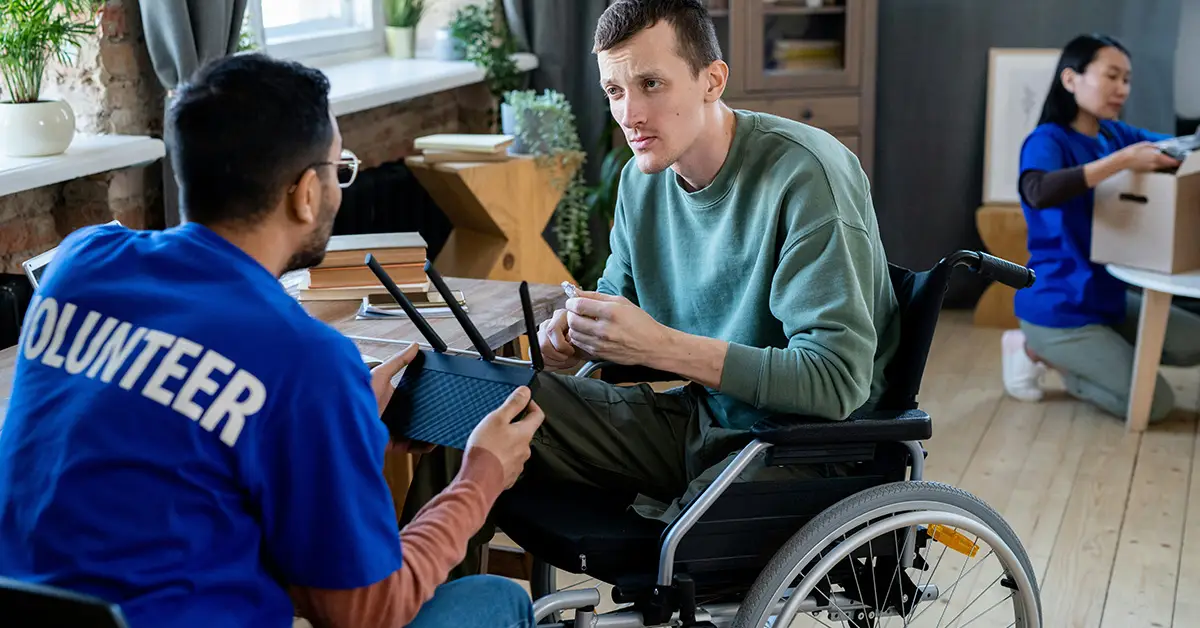 church community engagement perseverence: a volunteer helping a man in a wheelchair